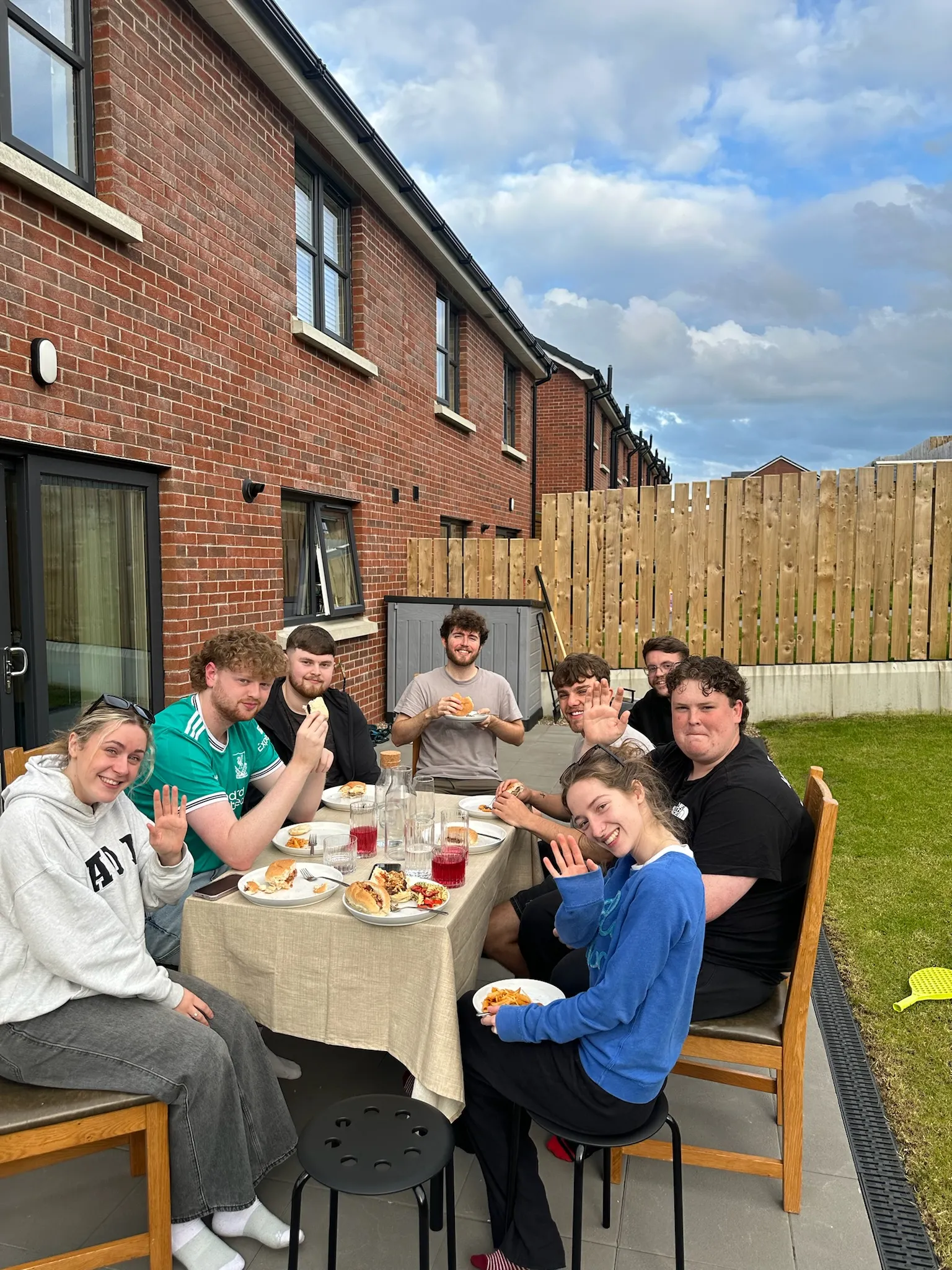 Young adults sharing food together at homegroup.